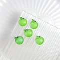 Five cute green resin apple charms on a textured glass plate for DIY crafts and jewelry - Green Apple