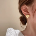 Close-up of a heart-shaped gold stud earring worn by a model in a minimalist style - Glossy Minimalist Heart (18# Silver Earring Post-Gold)
