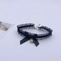 Close-up of black lace choker with satin bow and small golden bell for cat cosplay - Black Choker