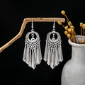 Ethnic style silver leaf tassel earrings hanging on branch against black background - Silver Hollow Ring Tassel Style (E4421-3)