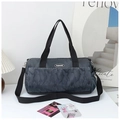 Close-up of large camouflage travel bag with adjustable strap and fashion label detail - Gray