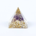 Pyramid resin ornament with crushed amethyst and gold foil flakes on white background - Amethyst