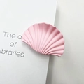 Pink fan-shaped marble texture hair claw clip with matte finish on a white book - Rubber Paint Pink