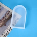 Macro view of a flexible arch-shaped silicone mold for DIY candles on a blue background - Arch Door Shape Candle Mold