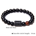 Beaded Virgo bracelet with 8mm black stones and a single red tiger eye bead - Virgo