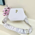 Detail view of white PU leather tote with hexagonal flap and gold hardware accents - White with Silver