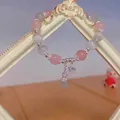 Detail of beaded bracelet with pink quartz, cat eye stones and silver bunny charms - Pink (Eco-friendly)