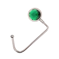 Detail view of silver metal bag hook featuring a faceted green crystal on white background - Dark Green