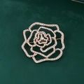 Exquisite hollow rose brooch in rose gold with shimmering diamonds on a green surface - XD11378-2 Rose Gold Hollow Rose