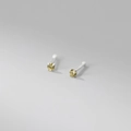 Macro shot of 999 sterling silver stud earrings with yellow round-cut stones in 4-prong setting - 999 Fine Silver Pair - 2mm Yellow Zirconia