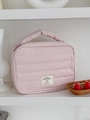 Pink quilted portable makeup bag with a soft handle and minimalist woven label design - Pink