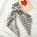 Detail of satin ponytail scrunchie with blue and yellow stripes and long streamers - Grey Stripe