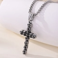 Silver skull cross pendant necklace on a minimalist white cylinder display - Cross