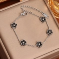 Bracelet en acier inoxydable argenté avec cinq pendentifs fleur en cristal noir et fermoir - Acier Zirconium Noir