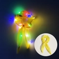 Yellow LED hair scrunchie with ribbons glowing in the dark and normal daylight view - Bunny Ear Glowing Yellow