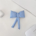 Detailed view of a blue quilted cosmetic pouch with a bow on a white desk workspace - Light Blue Plaid Bow Accessory
