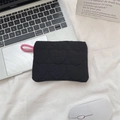 Detail of black quilted sanitary bag with heart patterns and pink zipper puller - Heart Quilted Black Coin Purse