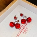 Detailed macro view of cherry-shaped earrings with red beads and white pearls on fabric - Silver Red Cherry Pearl Pendant (15#)