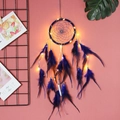 Blue handmade dream catcher with LED lights and feathers hanging on a pink wall - With LED Lights / Royal Blue
