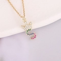 Macro detail of 18K gold letter S pendant with colorful zircon crown on a fine chain - Letter S Style