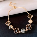 Elegant gold four-leaf clover adjustable bracelet with black petals and amber beads - Yellow Tower Crystal (Yellow)