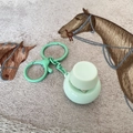 Light green round button fidget toy with plastic keychain on beige fabric background - Round Key With Light / Green