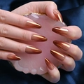 Long almond press-on nails with metallic bronze mirror finish on dark blue silk backdrop - BKS636 Laser Polar Bronze Orange Gold Style