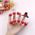 Three red flocked heart hair claw clips held in hand against a pink floral background - Set 2 (3-Piece Set)