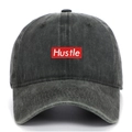 Close-up of a vintage washed baseball cap featuring a red Hustle embroidered patch - One Size / Army Green