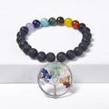 Detailed macro of a Tree of Life pendant on a chakra beaded energy yoga bracelet - Lava Rock Bracelet