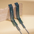 Long blue and green rhinestone tassel earrings on a textured stone display - Blue Gradient