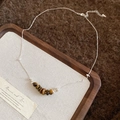 Detailed close-up of tiger eye stone beads on a silver chain over a wooden tray - Crushed Stone Beaded Style / Silver-Coffee
