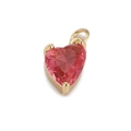 Macro shot of heart-shaped pink zircon pendant with gold-plated metal setting - Pink