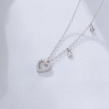 Close-up of S925 silver hollow heart pendant with sparkling cubic zirconia on a fine chain - 925 Silver / Silver