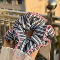 Blue and white striped scrunchie with pink piping detail held in hand - Pink Trim Blue-Black Stripe Scrunchie
