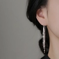 Elegant long silver tassel earrings with delicate ball chain design on female model - Round Bead Tassel Ear Threader