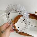 Elegant beaded headband with transparent acrylic flowers and crystals on a silver frame - White