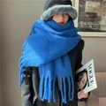 Detailed texture of thick blue mohair scarf with fringes worn with dark coat - Royal Blue
