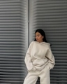 Detail of loose-fit beige hooded sweatshirt and matching joggers in soft knit fabric - S / Apricot