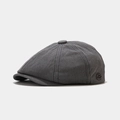 Close-up of dark grey newsboy cap showing twill cotton texture and metal fashion label - Dark Gray