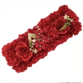 Detailed view of red artificial flower row with beige hydrangeas and green foliage - Red