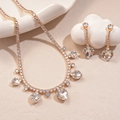 Detailed view of luxury gold heart pendant necklace and drop earrings with zircon fringe - White Heart Style