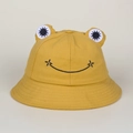 Close-up of a yellow frog bucket hat with 3D eyes and embroidered smiley face detail - Adult / Yellow