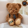 Brown plush teddy bear toy with blue floral backpack and tie accessory detail - Dark Brown / 21cm