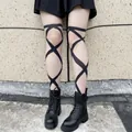 Detail of black pantyhose with criss-cross pattern styled with platform boots - One Size / Black Criss-cross