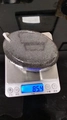Gray oval volcanic pumice stone for foot exfoliation showing 85.4g weight on scale - 10x7x4cm Synthetic / Black
