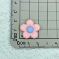 Top view of a 2.5cm pink frosted flower resin charm on a grid cutting mat for DIY crafts - 09# Pink with Blue Center 2*2cm