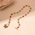 Detailed view of gold toggle clasp necklace with colorful gems and a butterfly charm - Multicolor Butterfly Necklace