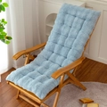 Light blue rabbit fur chair cushion on a wooden rocking chair in a cozy home setting - Blue