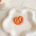 Cute Korean style orange pretzel hair clip on white ceramic tray with warm aesthetic - Heart Cookie